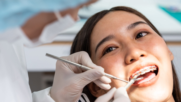 A patient getting treated by an orthodontist who uses the OrthoPhoto app
